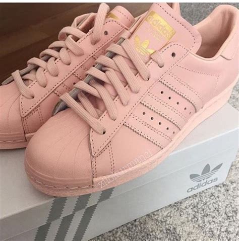 pink adidas superstar sneakers.